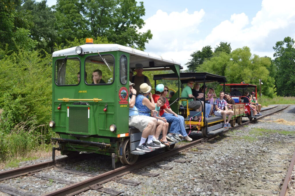 photo of kids and elders on the open air Ride The Rail cars